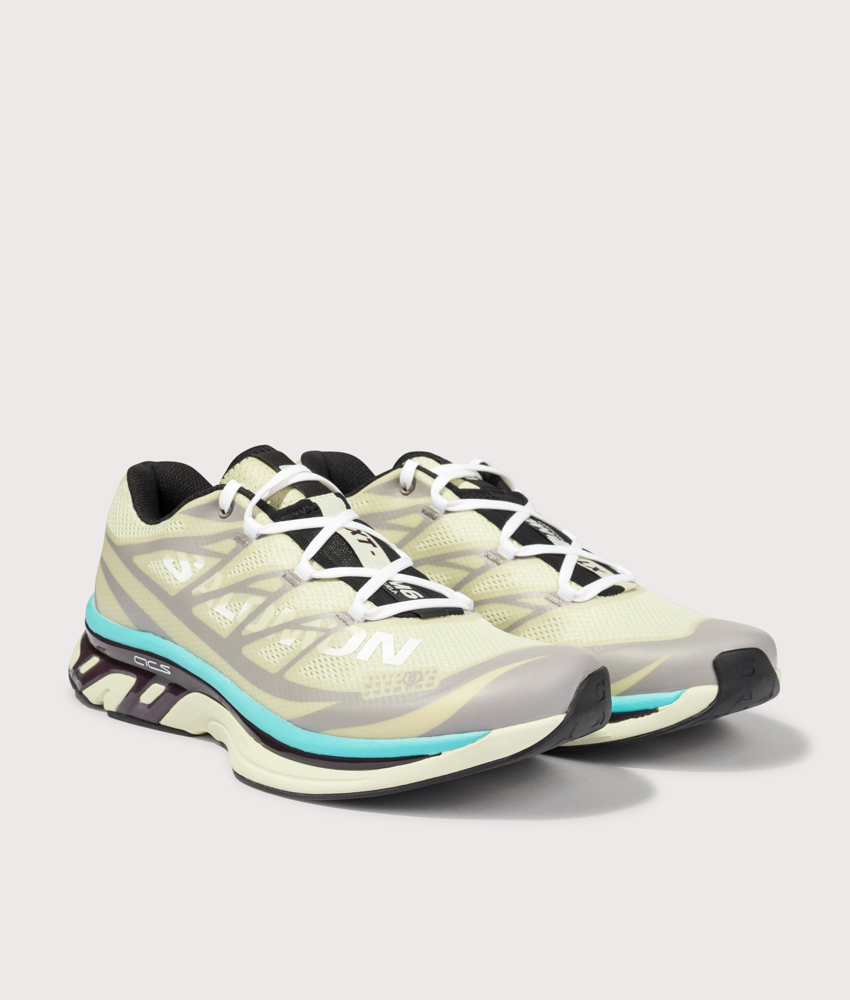 MM6 X Salomon XT Sneakers in Asparagus Green/Gull/Blue Curacao by MM6 Maison Margiela. Shot by EQVVS. Front angled shot.