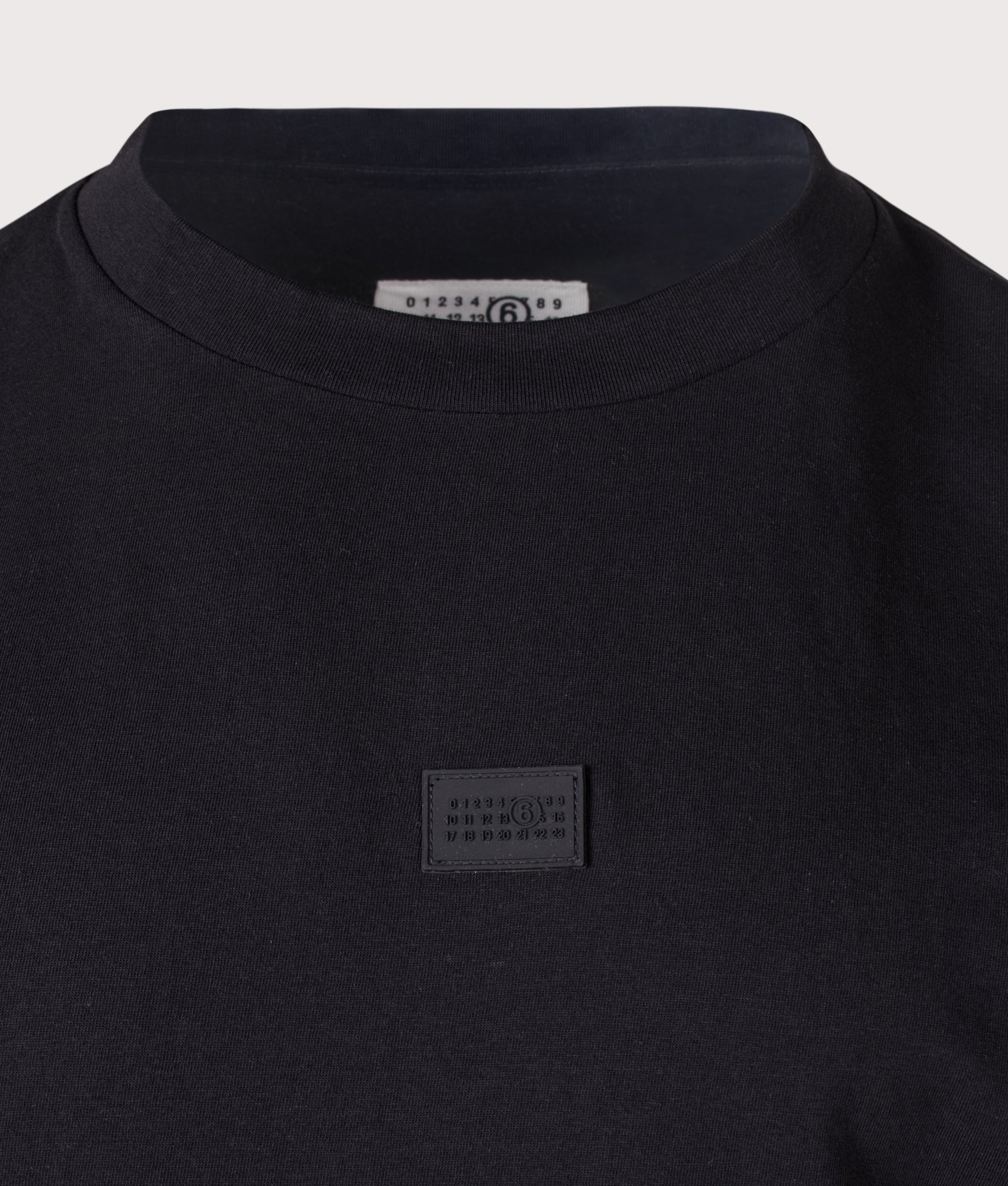 MM6 Maison Margiela Relaxed Fit Numeric T-Shirt in Black at EQVVS Menswear. Detail shot.