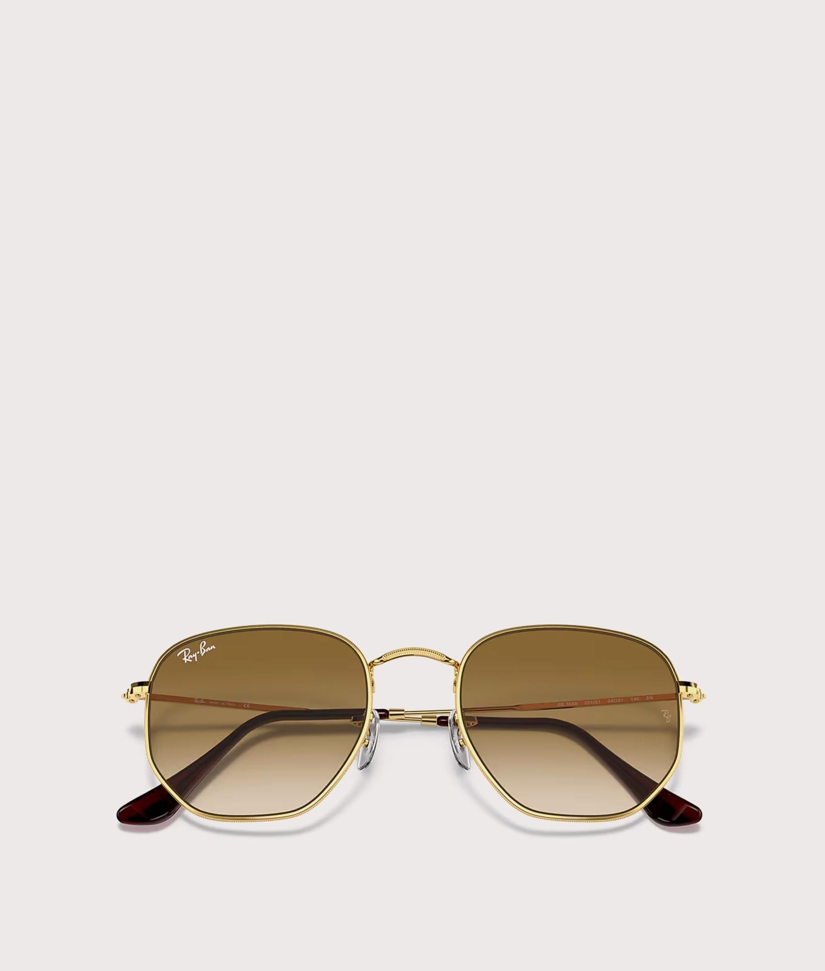Hexagonal Flat Lens Sunglasses in Polished Arista Gold-Brown Lens by Ray-Ban. Shot by EQVVS. Collapsed shot.
