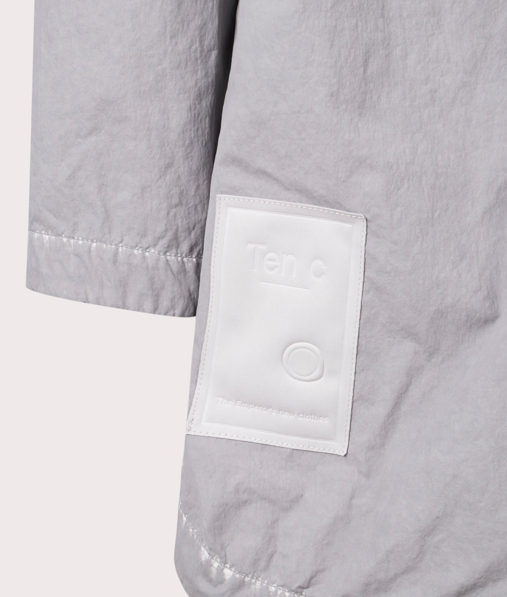 Shadow Dyed Long Raincoat in Pale Taupe by Ten C at EQVVS Menswear. Detail Shot.
