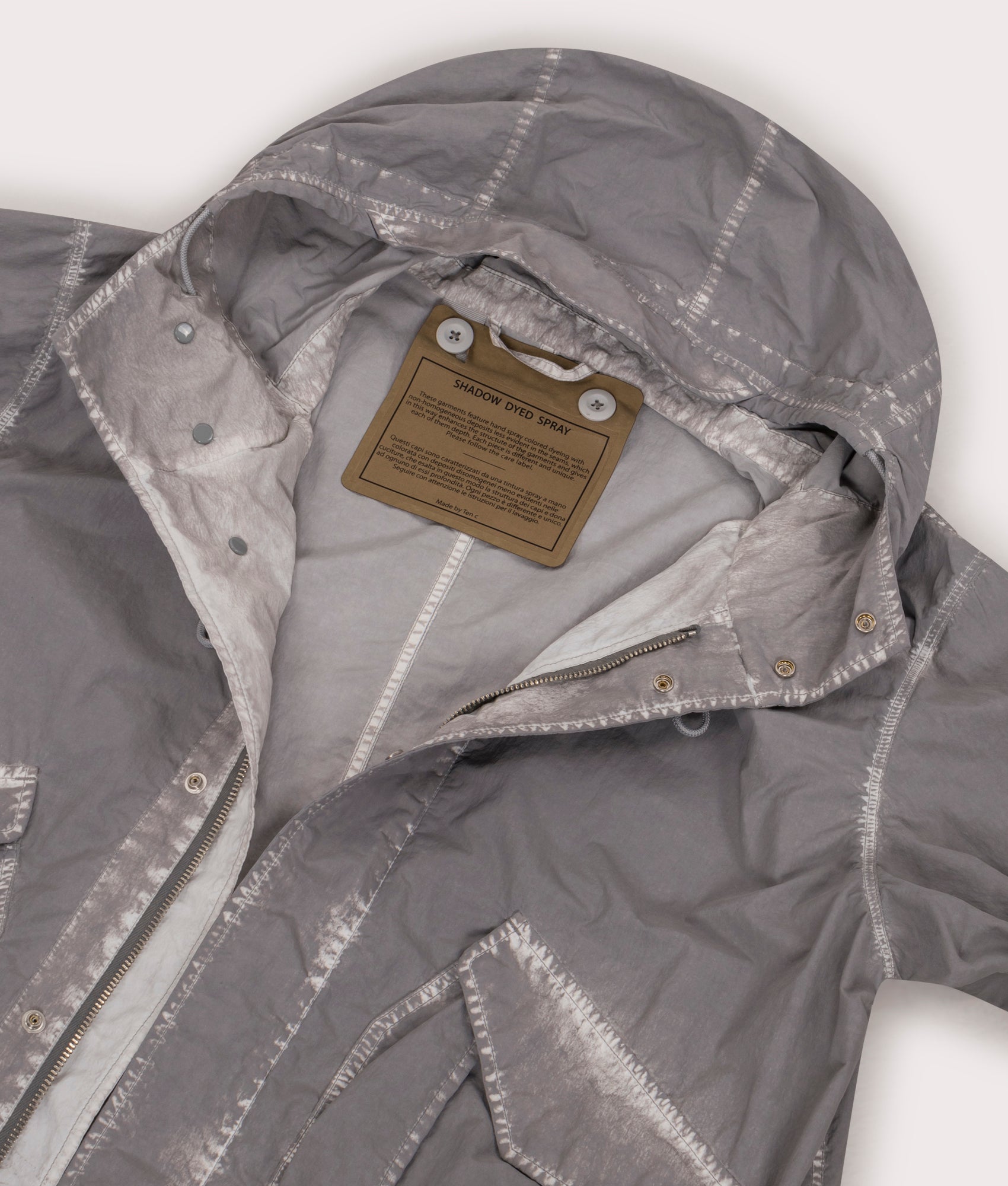 Shadow Dyed Long Raincoat in Pale Taupe by Ten C at EQVVS Menswear. Hood Detail Shot.