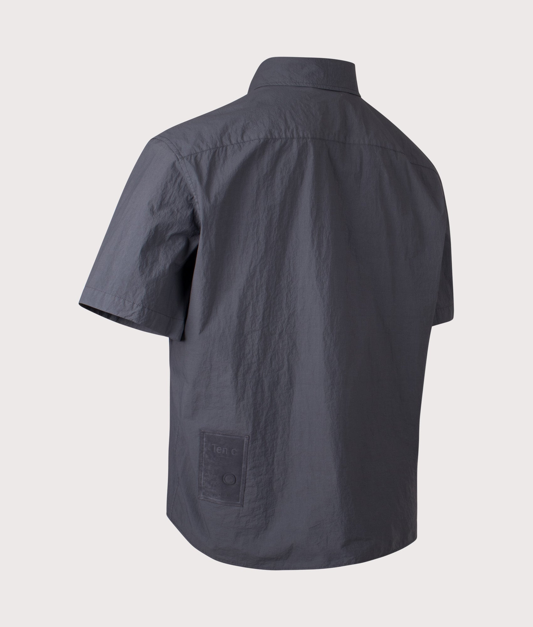 Ten c Garment Dyed Tactel Short Sleeve Shirt in Carbon Grey at EQVVS Menswear. Angled back shot.