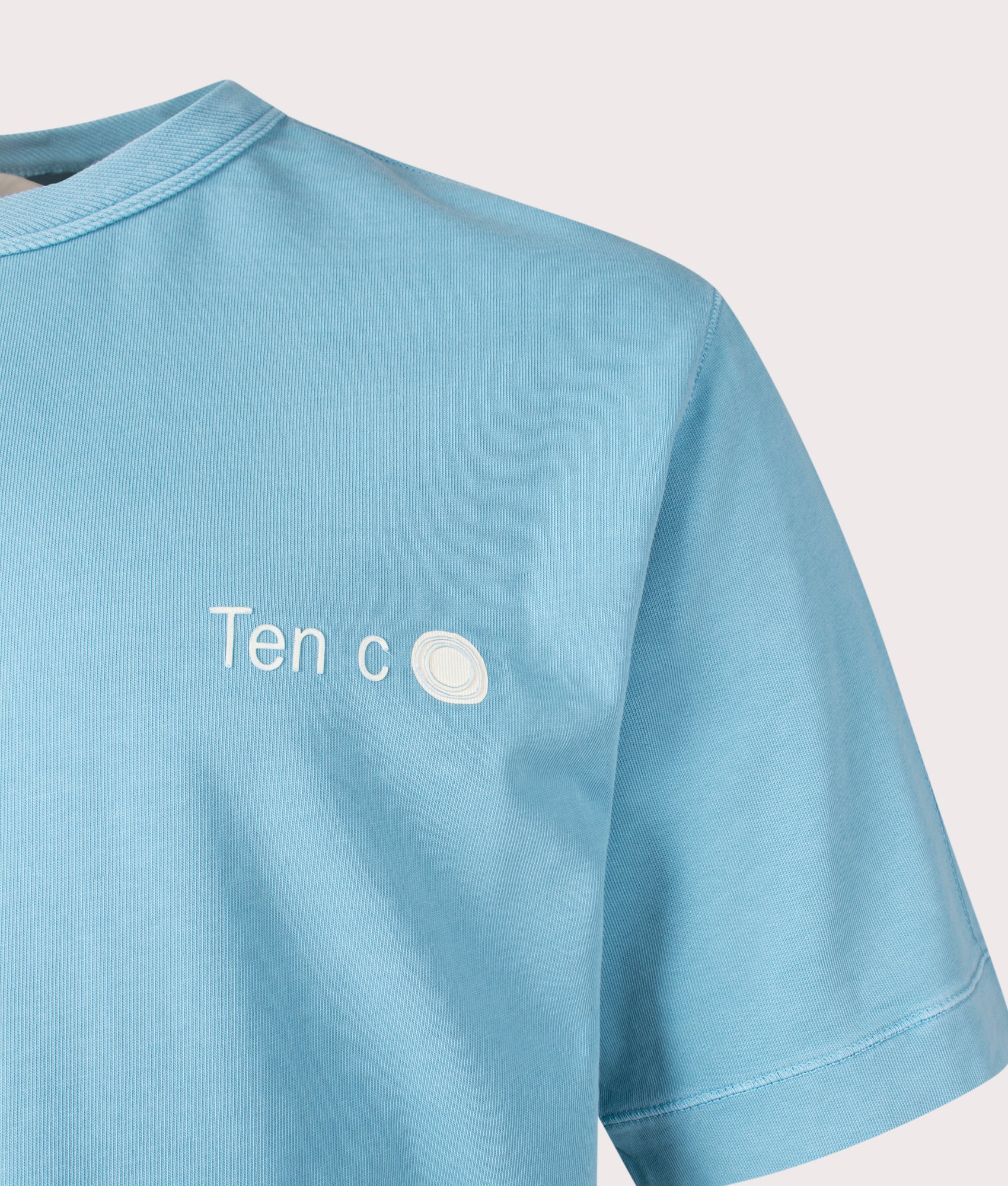 Ten c Mineral Garment Dyed T-Shirt in Sky Blue Lake, 100% Cotton at EQVVS. Close-up shot.