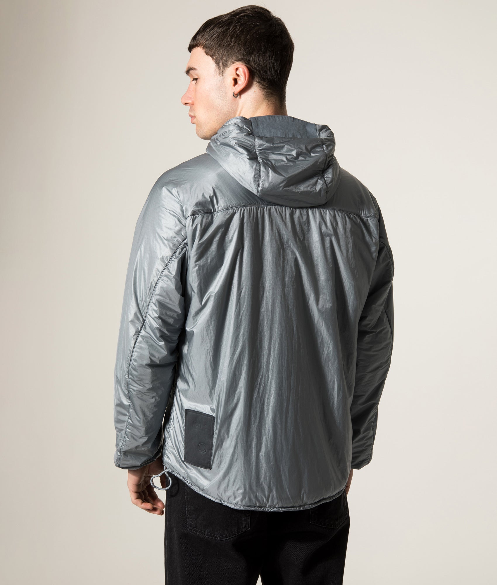 Ten c Piece Dyed Ripstop Primaloft Mid Layer Jacket in Quarry Grey at EQVVS Menswear. Model back shot.