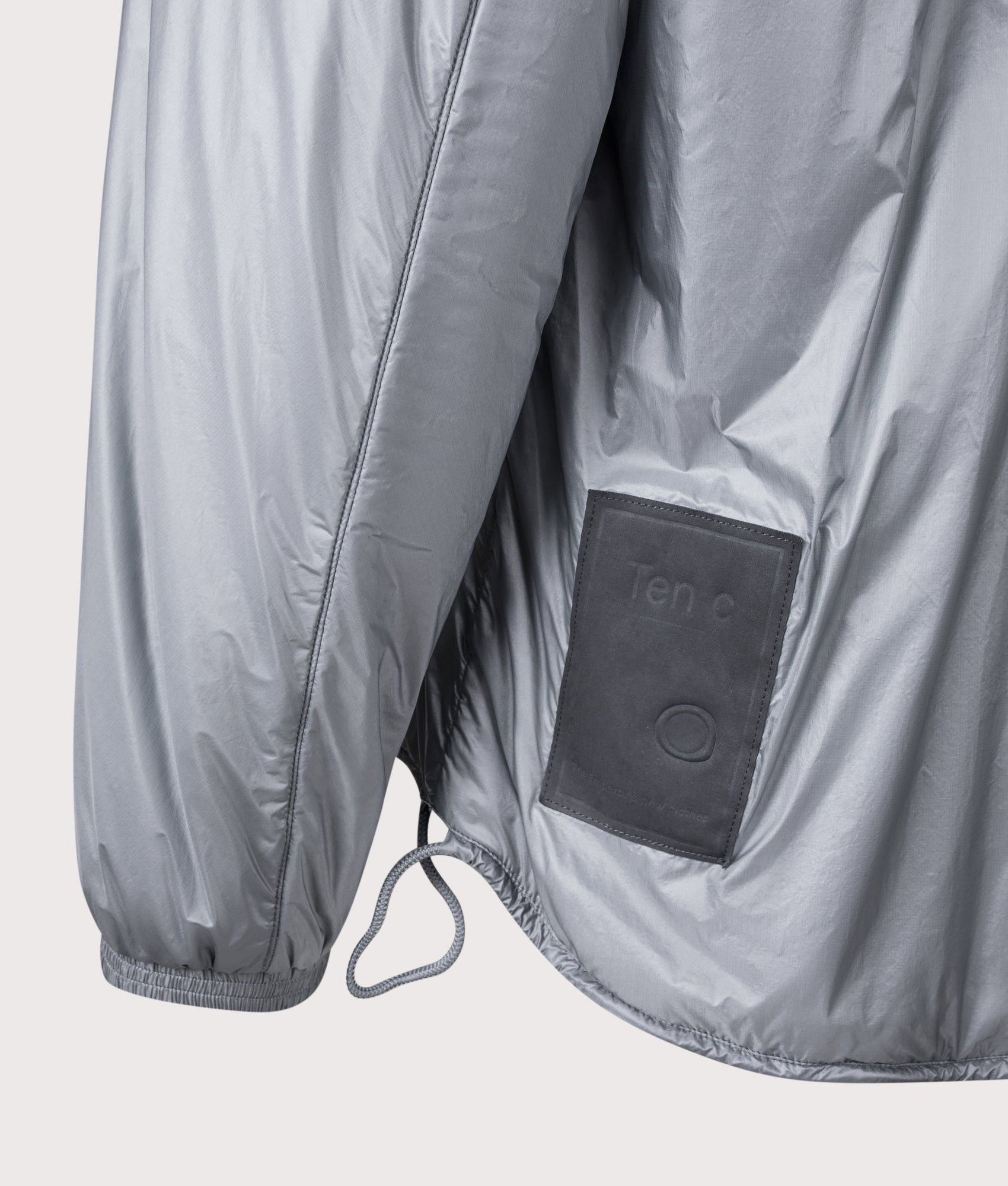 Ten c Piece Dyed Ripstop Primaloft Mid Layer Jacket in Quarry Grey at EQVVS Menswear. Back detail shot.