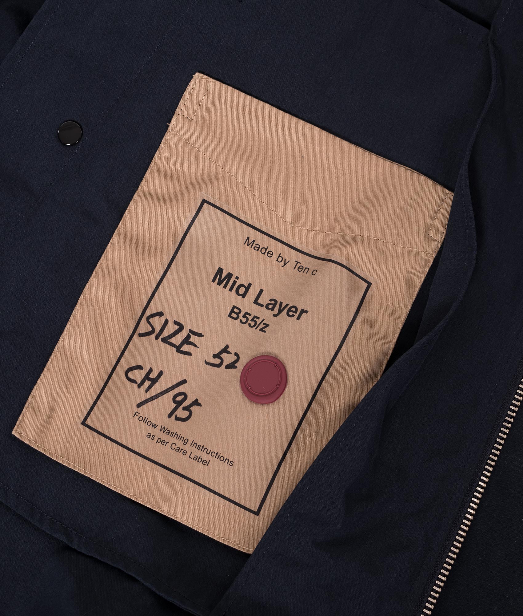 Ten c Piece Dyed OJJ Mid Layer Jacket in Blue at EQVVS Menswear. Label detail shot.