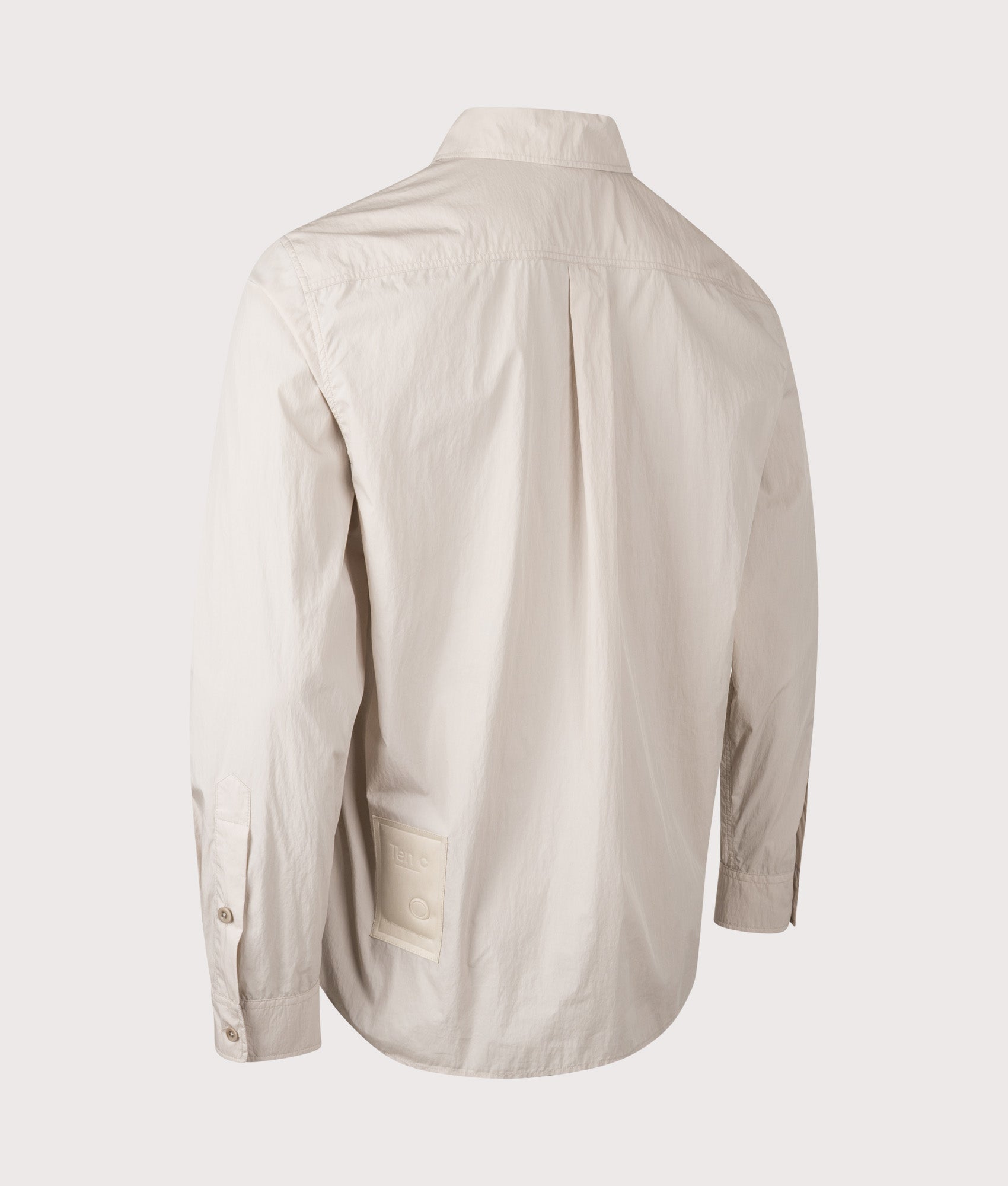 Ten c Piece Dyed Pocket Shirt in Grey Sand at EQVVS Menswear. Angled back shot.