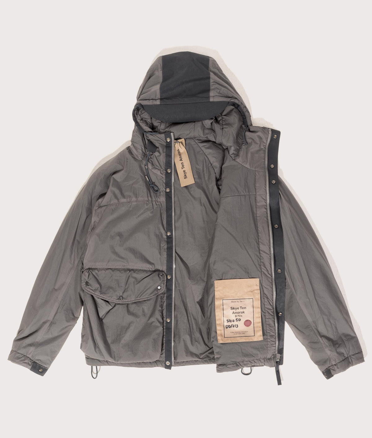 Lightly Padded Skye Ten Anorak Jacket by Ten c in Iron Grey. Shot by EQVVS. Flat shot.