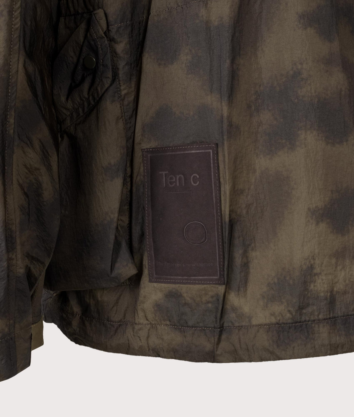 Camou Skye Ten Anorak Jacket by Ten c in Olive Green. Shot by EQVVS. Badge detail shot.
