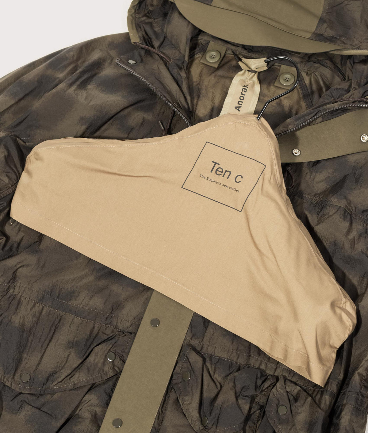 Camou Skye Ten Anorak Jacket by Ten c in Olive Green. Shot by EQVVS. Branded hanger shot.
