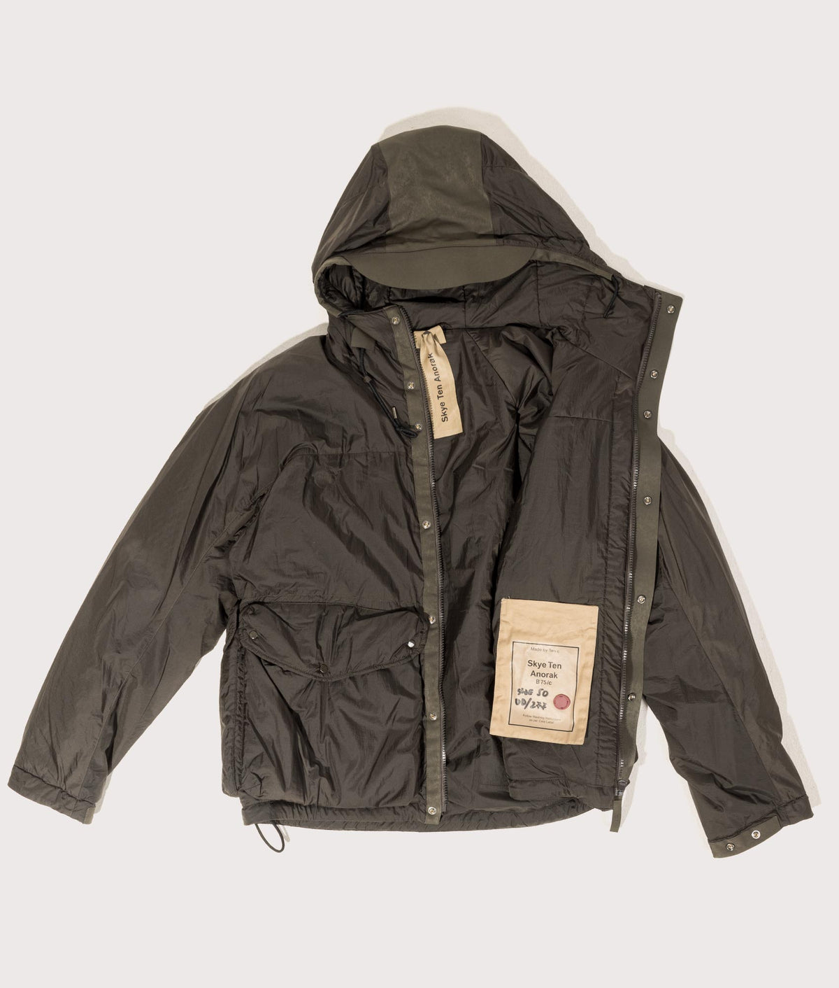 Lightly Padded Skye Ten Anorak Jacket by Ten c in Green Lizard. Shot by EQVVS. Flat shot.