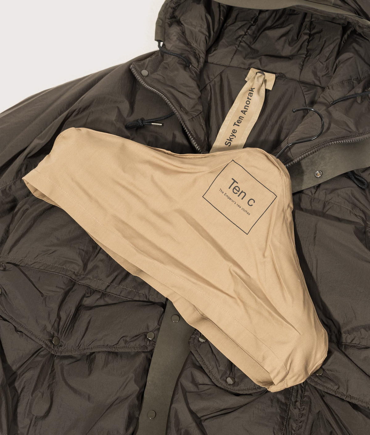 Lightly Padded Skye Ten Anorak Jacket by Ten c in Green Lizard. Shot by EQVVS. Branded hanger shot.