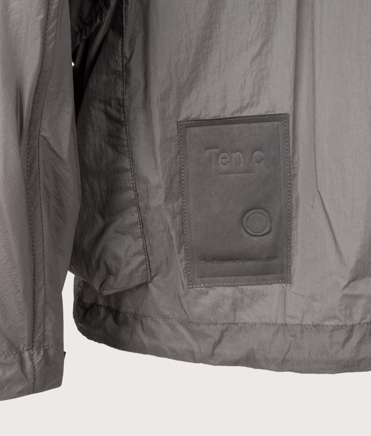 Skye Ten Anorak Jacket by Ten c in Iron Grey. Shot by EQVVS. Badge detail shot.