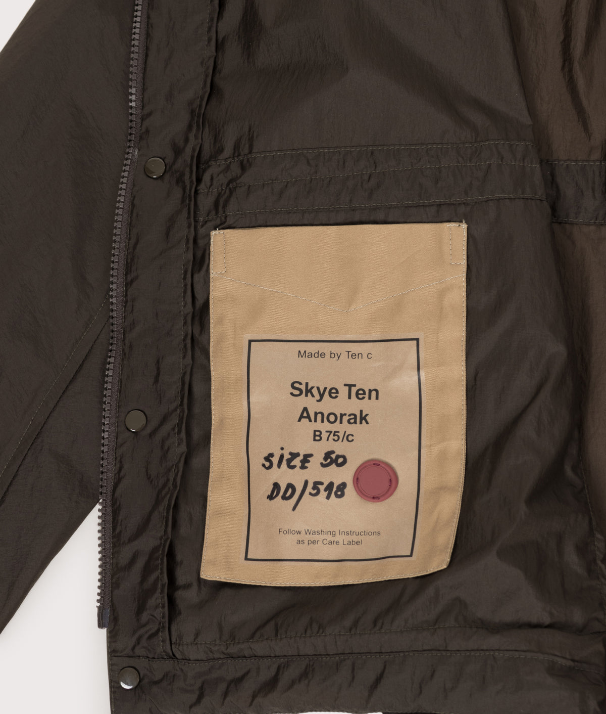 Ten c Skye Ten Anorak Jacket in Green Lizard at EQVVS Menswear. Inside label shot.
