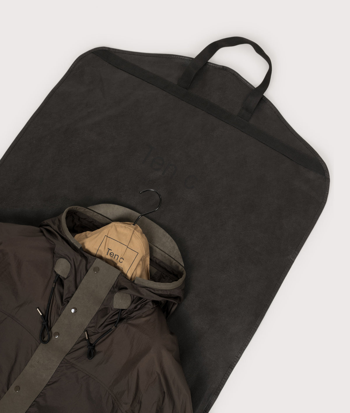 Ten c Skye Ten Anorak Jacket in Green Lizard at EQVVS Menswear. Bag shot.