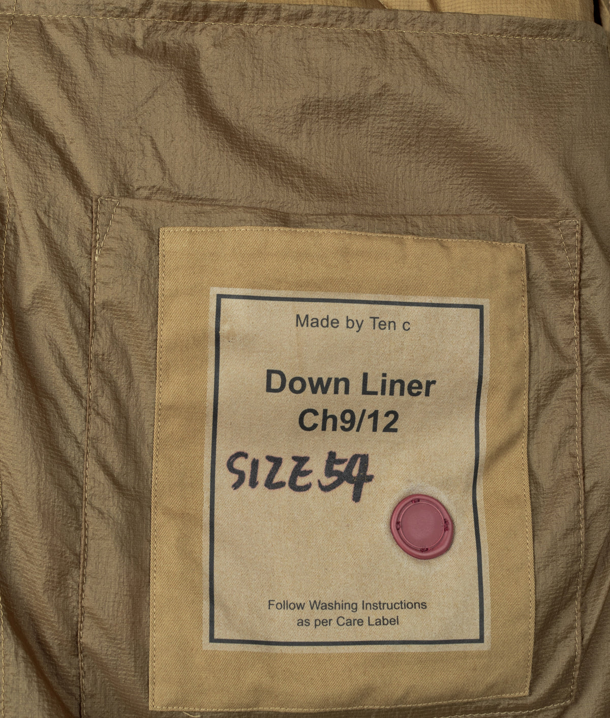 Ten c Izumo Down Liner Jacket in Cumin Brown at EQVVS Menswear. Inside detail shot.