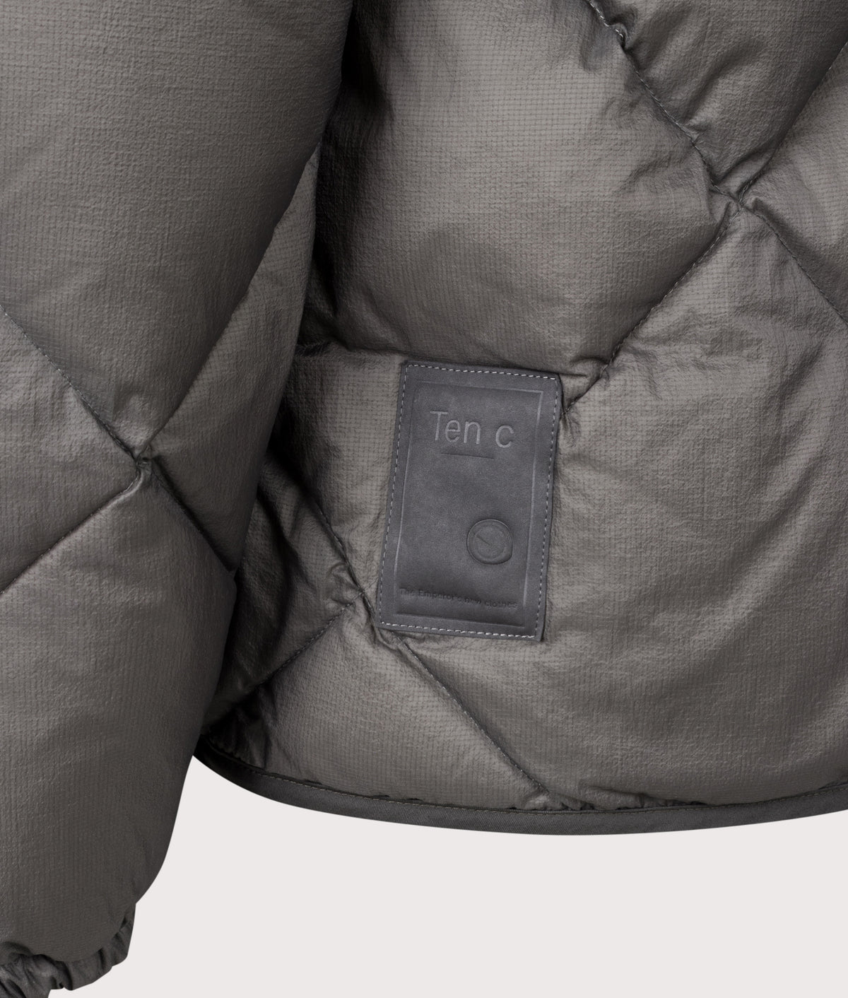 Ten c Izumo Down Liner Jacket in Soot Grey at EQVVS Menswear. Detail shot.