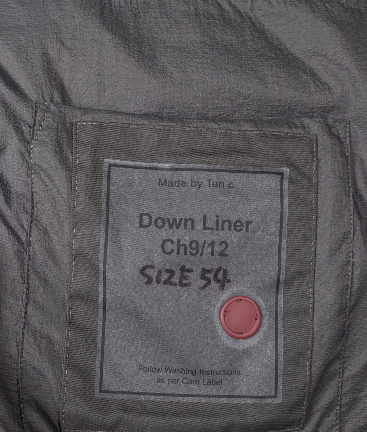 Ten c Izumo Down Liner Jacket in Soot Grey at EQVVS Menswear. Inside detail shot.