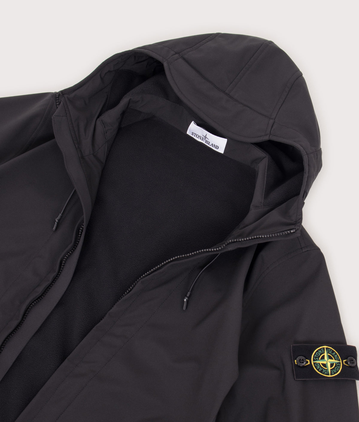 Stone Island Soft Shell-R_E DYE® Technology Jacket in Black at EQVVS Menswear. Flat shot.