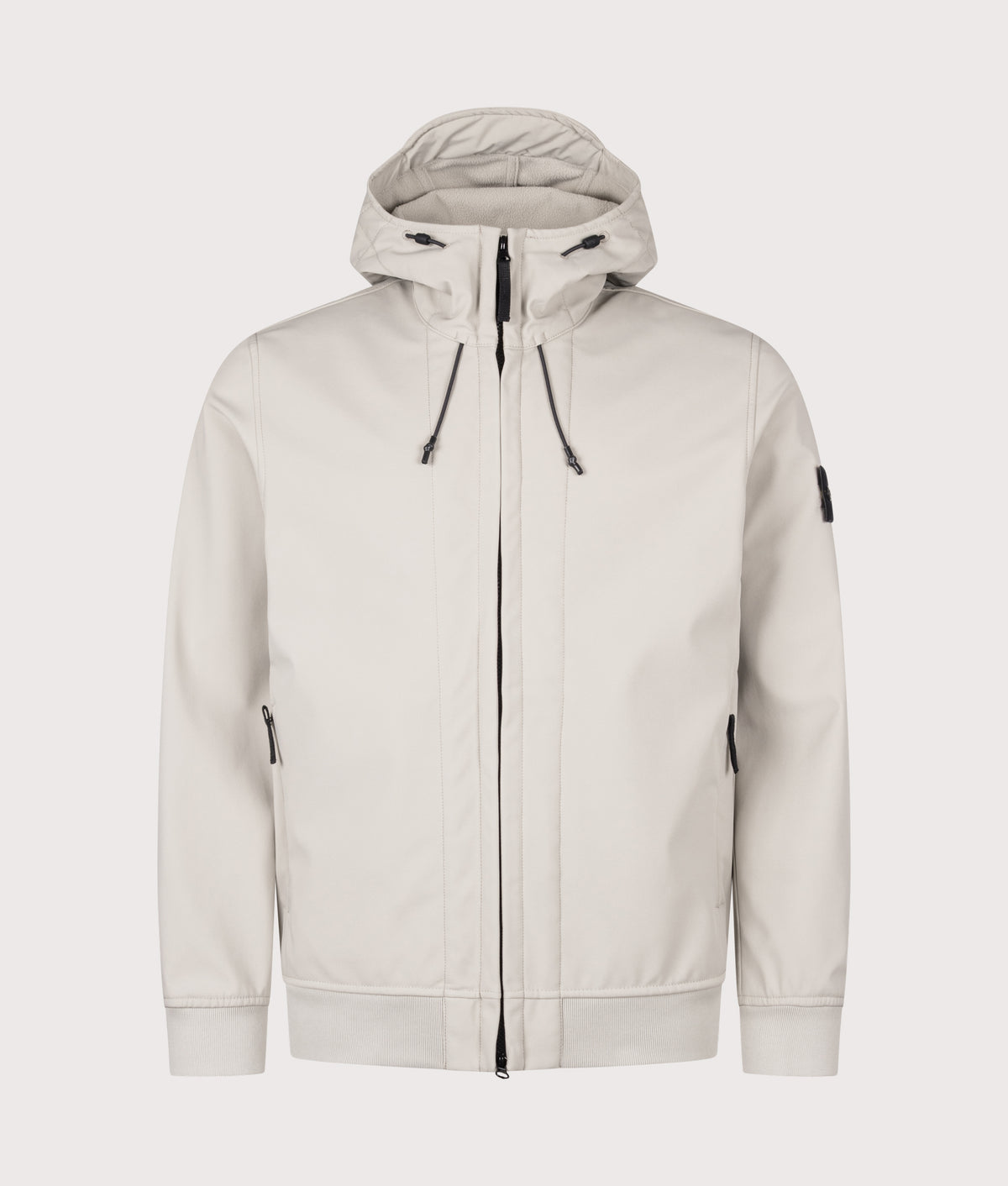 Stone Island Soft Shell-R_E.Dye® Technology Jacket in sand at EQVVS Menswear. Front shot.
