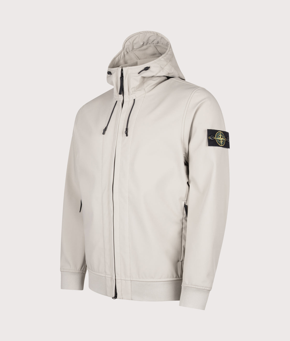 Stone Island Soft Shell-R_E.Dye® Technology Jacket in sand at EQVVS Menswear. Front shot.