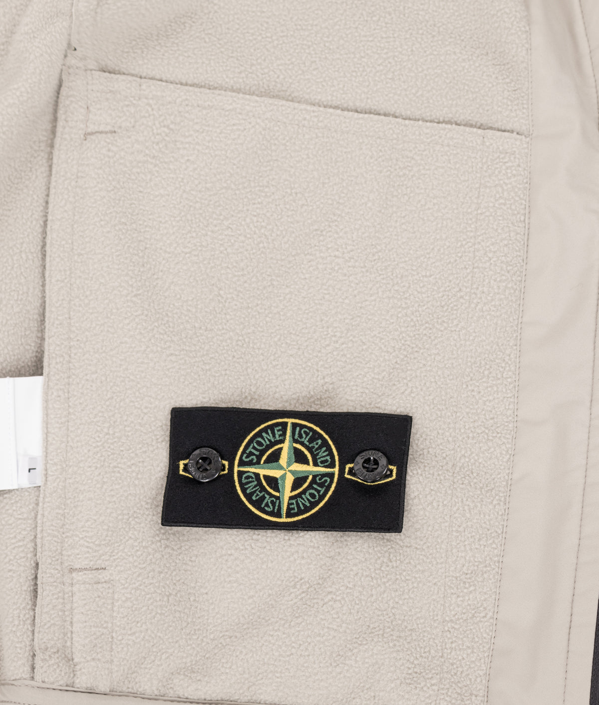 Stone Island Soft Shell-R_E.Dye® Technology Jacket in sand at EQVVS Menswear. Detail shot.
