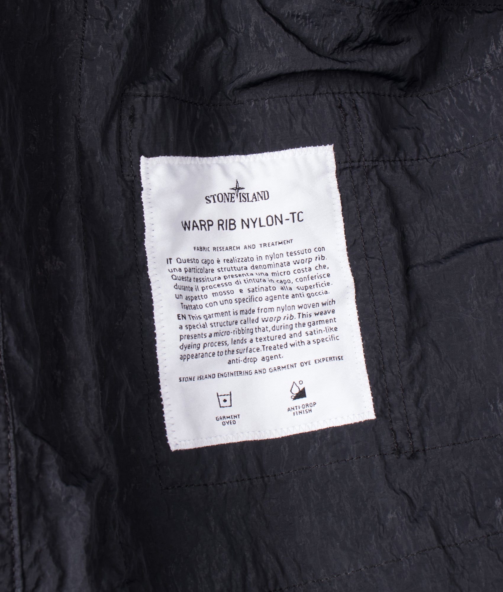 Stone Island Warp Rib Nylon-TC Jacket in Black at EQVVS Menswear. Label shot.