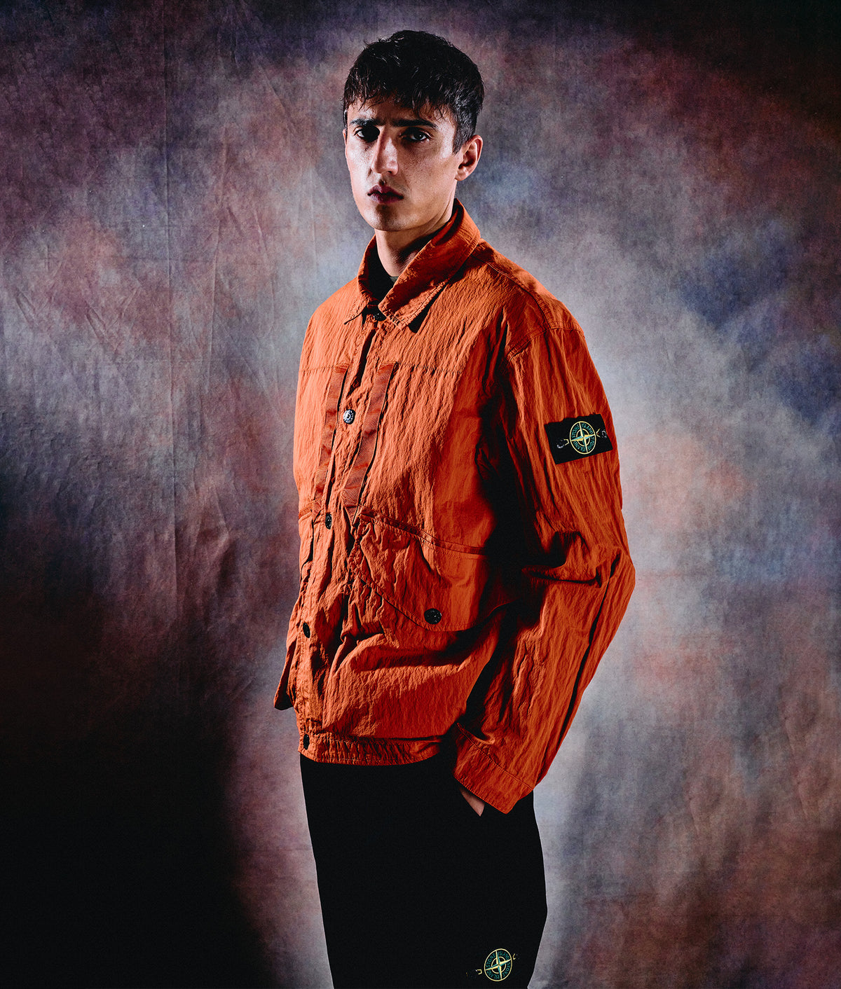 Stone Island Warp Rib Nylon-TC Jacket in Burnt Orange at EQVVS Menswear. Campaign shot.