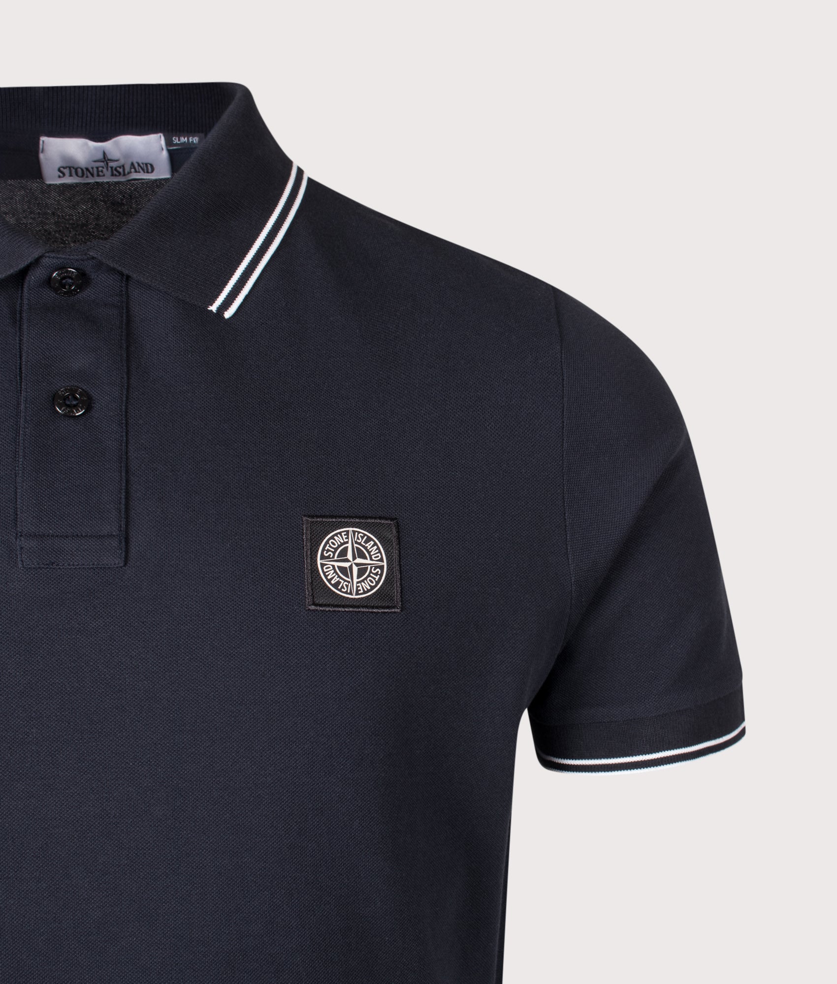 Stone Island Slim Fit Organic Cotton Polo Shirt in Navy Blue at EQVVS Menswear. Detail Shot. 