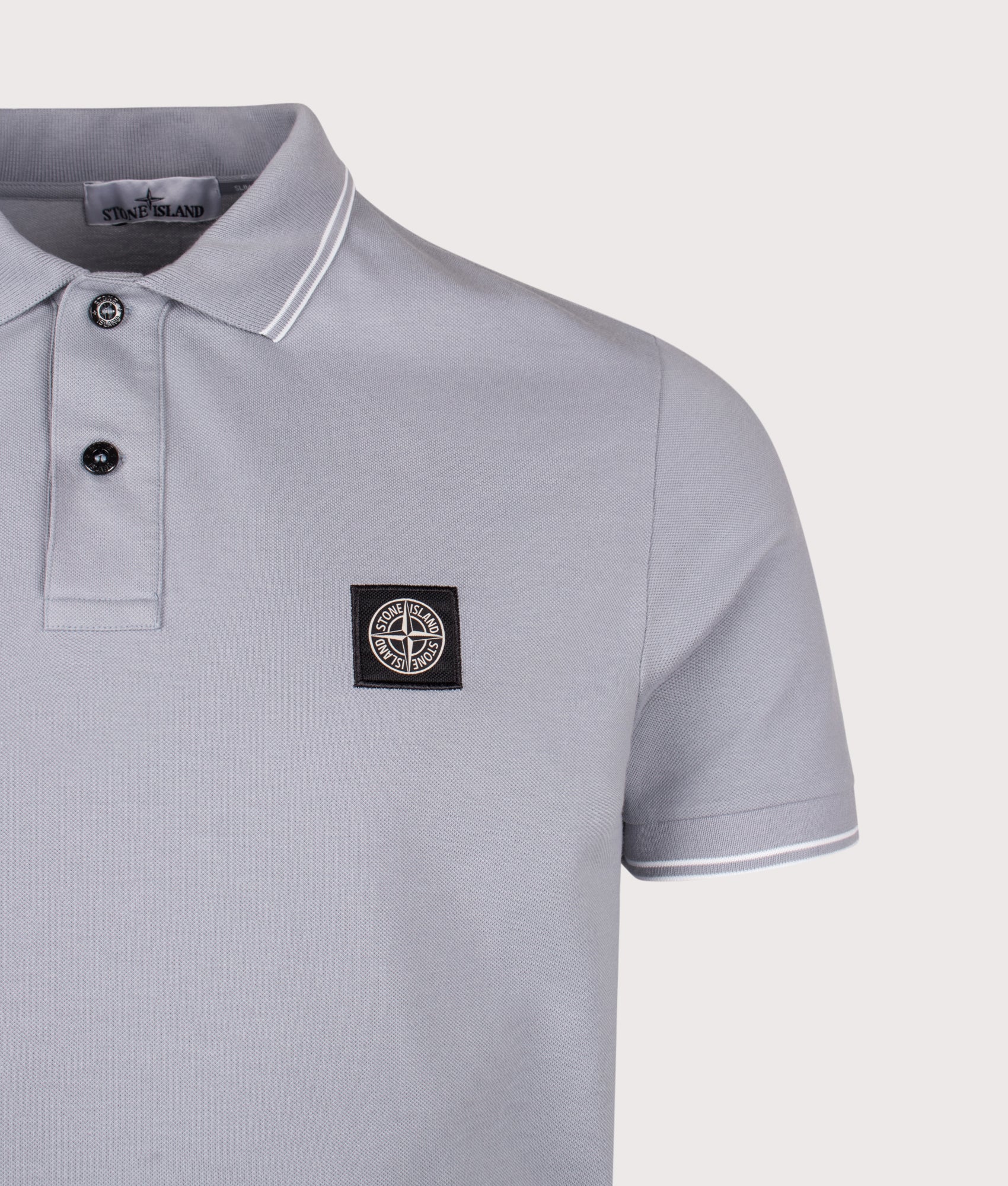 Stone Island Slim Fit Organic Cotton Polo Shirt in Ash Grey at EQVVS Menswear. Detail shot.