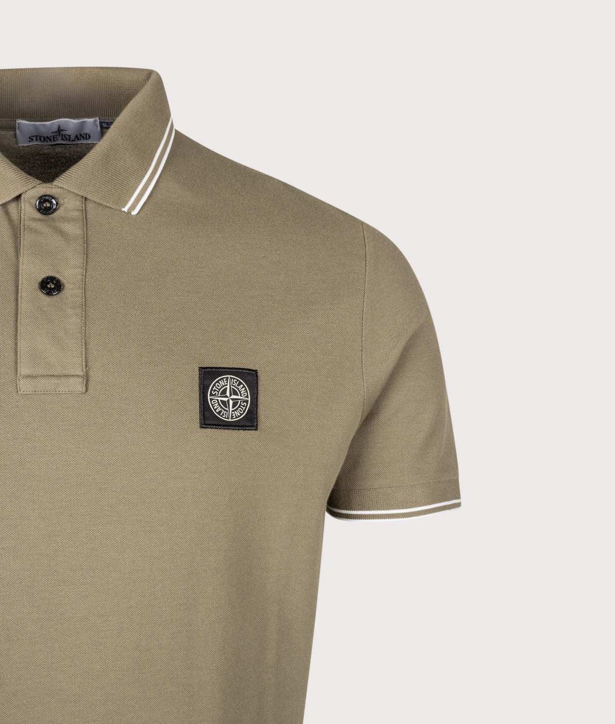 Stone Island staple Slim Fit Organic Cotton Polo Shirt in Military Green at EQVVS Menswear. Detail shot.
