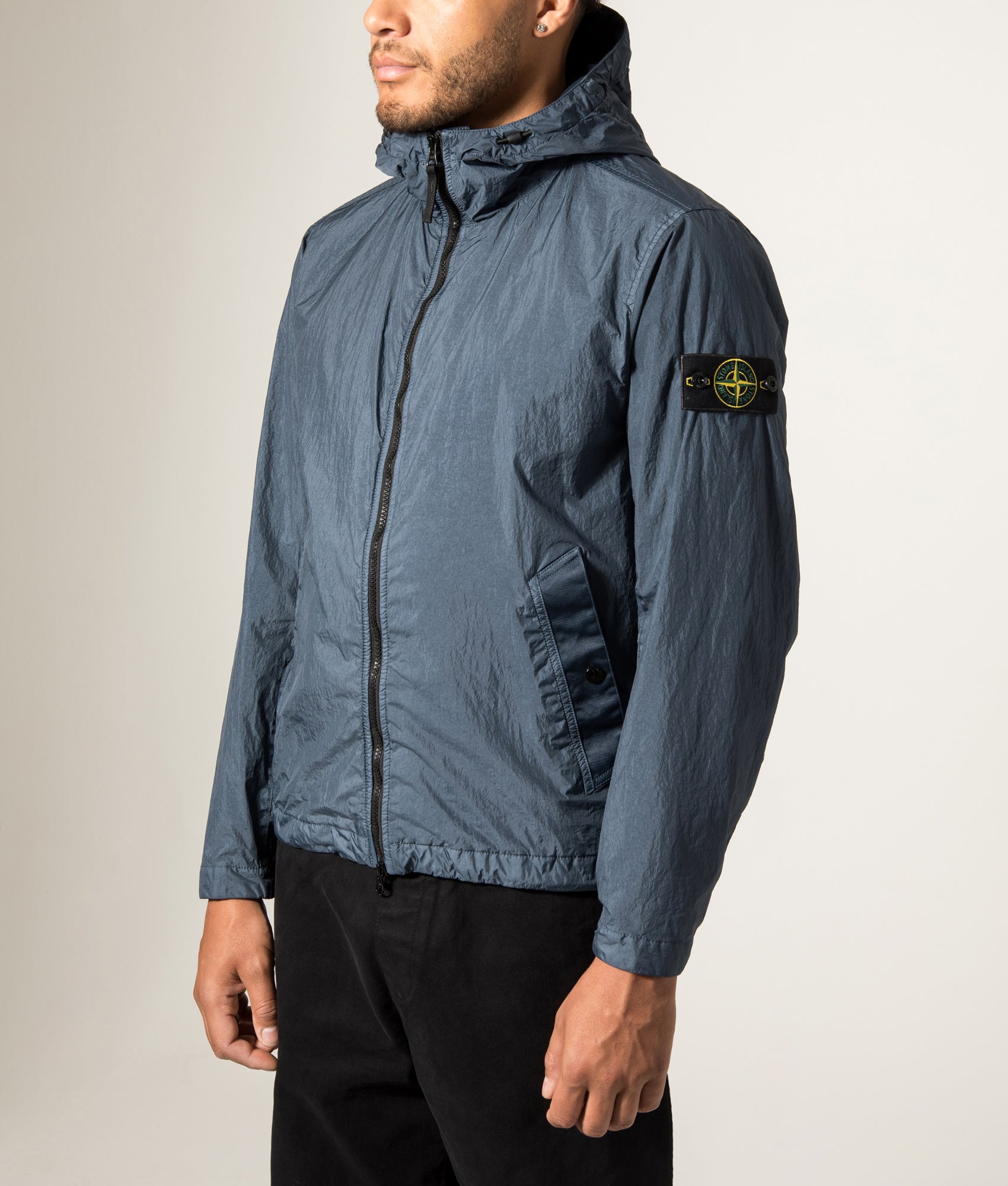 Stone Island Garment Dyed Crinkle Reps NY Jacket in Slate Blue at EQVVS Menswear. Angled model front shot.
