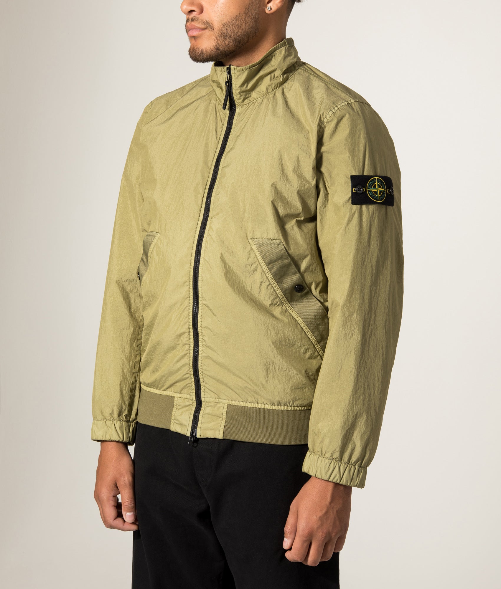 Stone Island Garment Dyed Crinkle Reps NY Jacket in Laurel Green at EQVVS Menswear.  Model angled front shot.