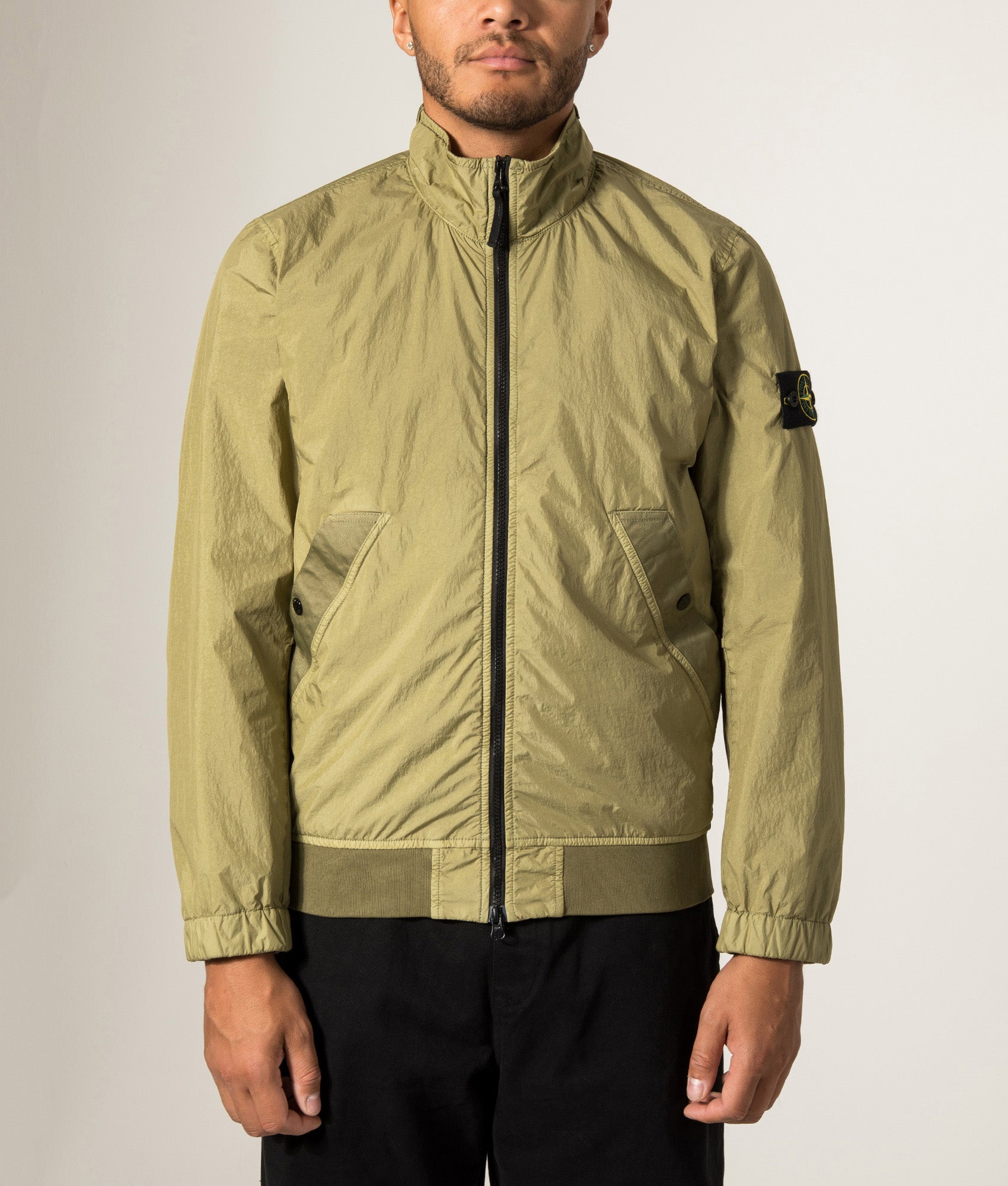 Stone Island Garment Dyed Crinkle Reps NY Jacket in Laurel Green at EQVVS Menswear.  Model front shot.