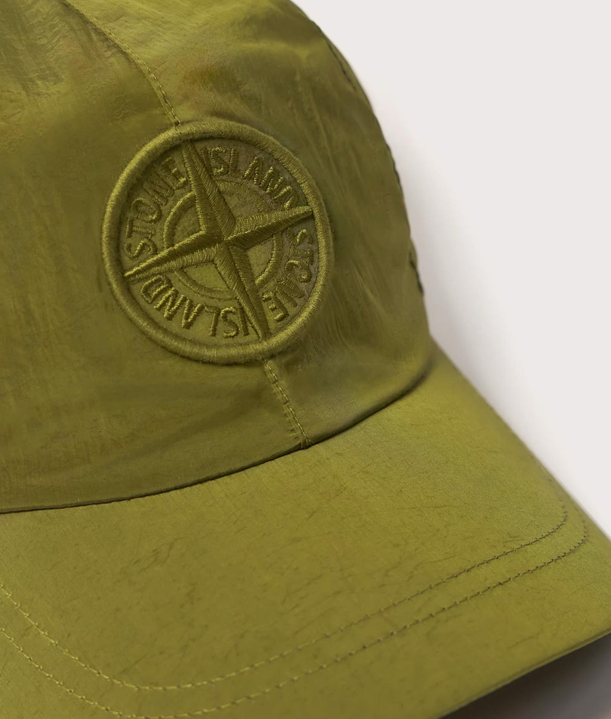Stone Island Nylon Metal in Econyl® Cap in Cactus at EQVVS Menswear. Detail shot.