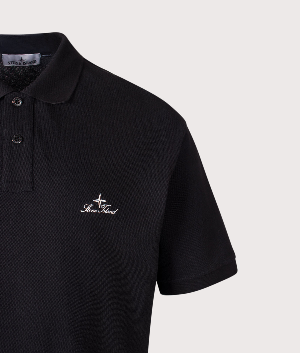 Stone Island Regular Fit 50/2 Organic Pique Polo Shirt in Black at EQVVS Menswear. Detail shot.