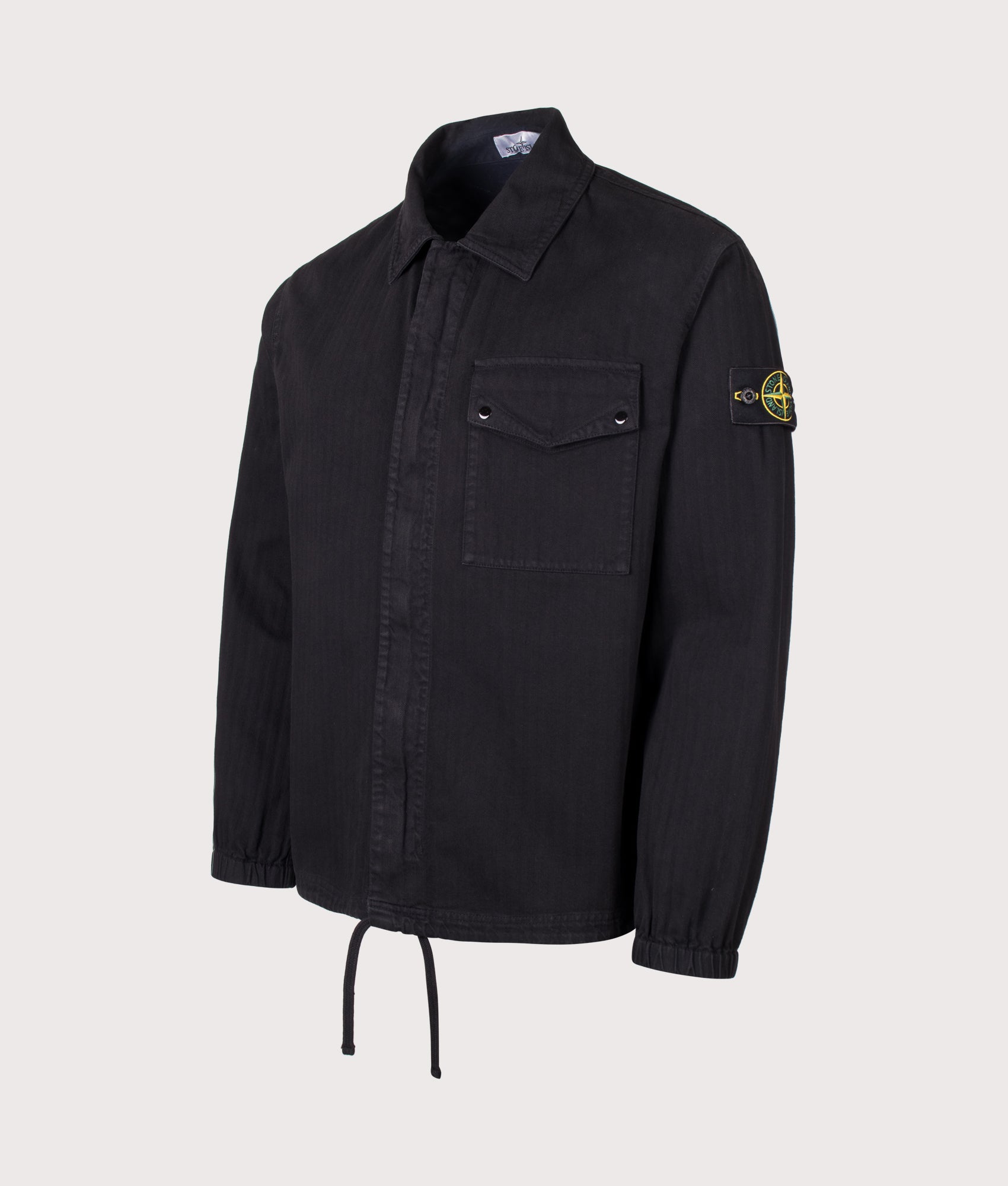 Stone Island Organic Cotton Twill Overshirt in Black at EQVVS Menswear. Angled front shot.