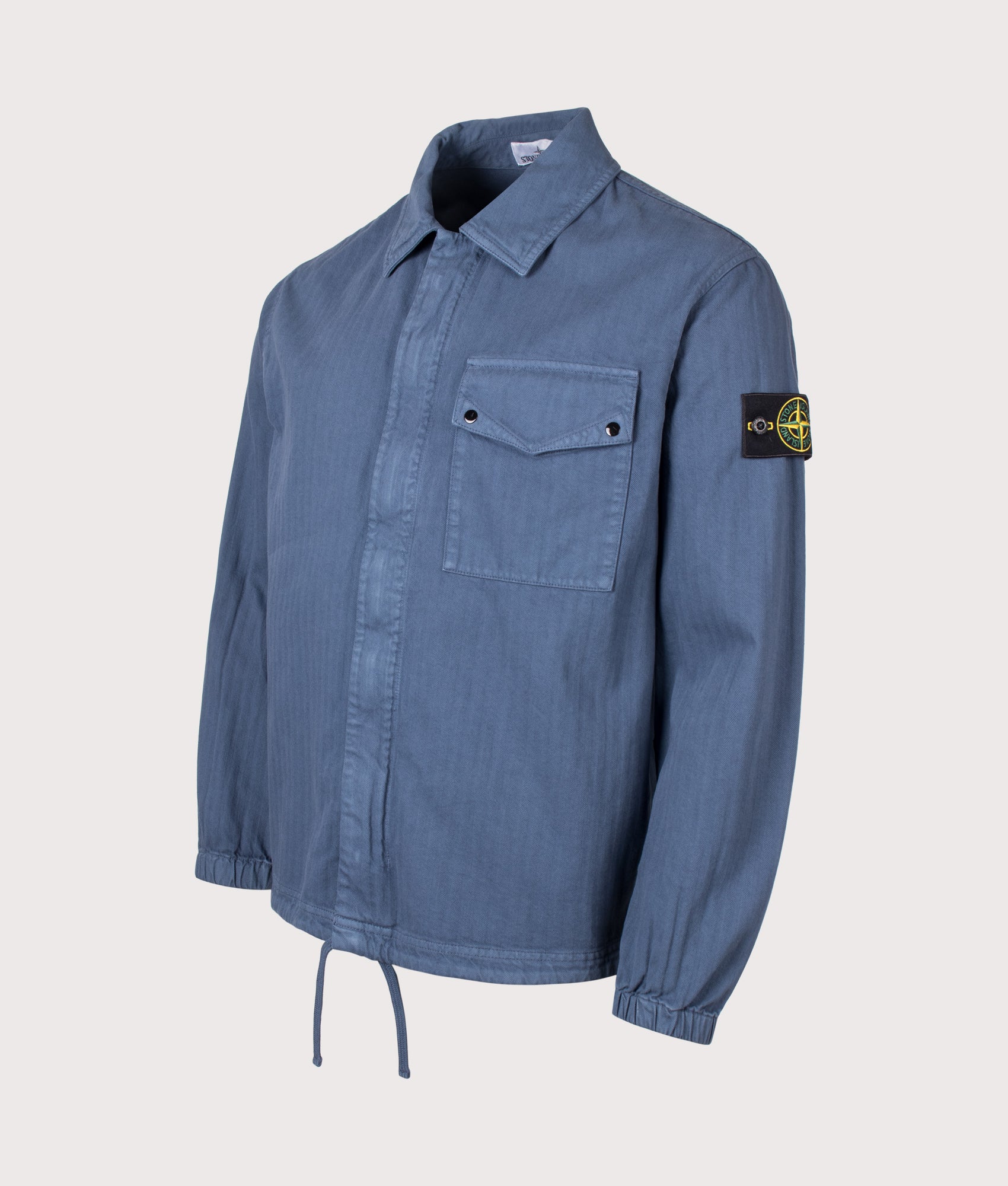 Stone Island Organic Cotton Twill Overshirt in Slate Blue at EQVVS Menswear. Angled front shot.