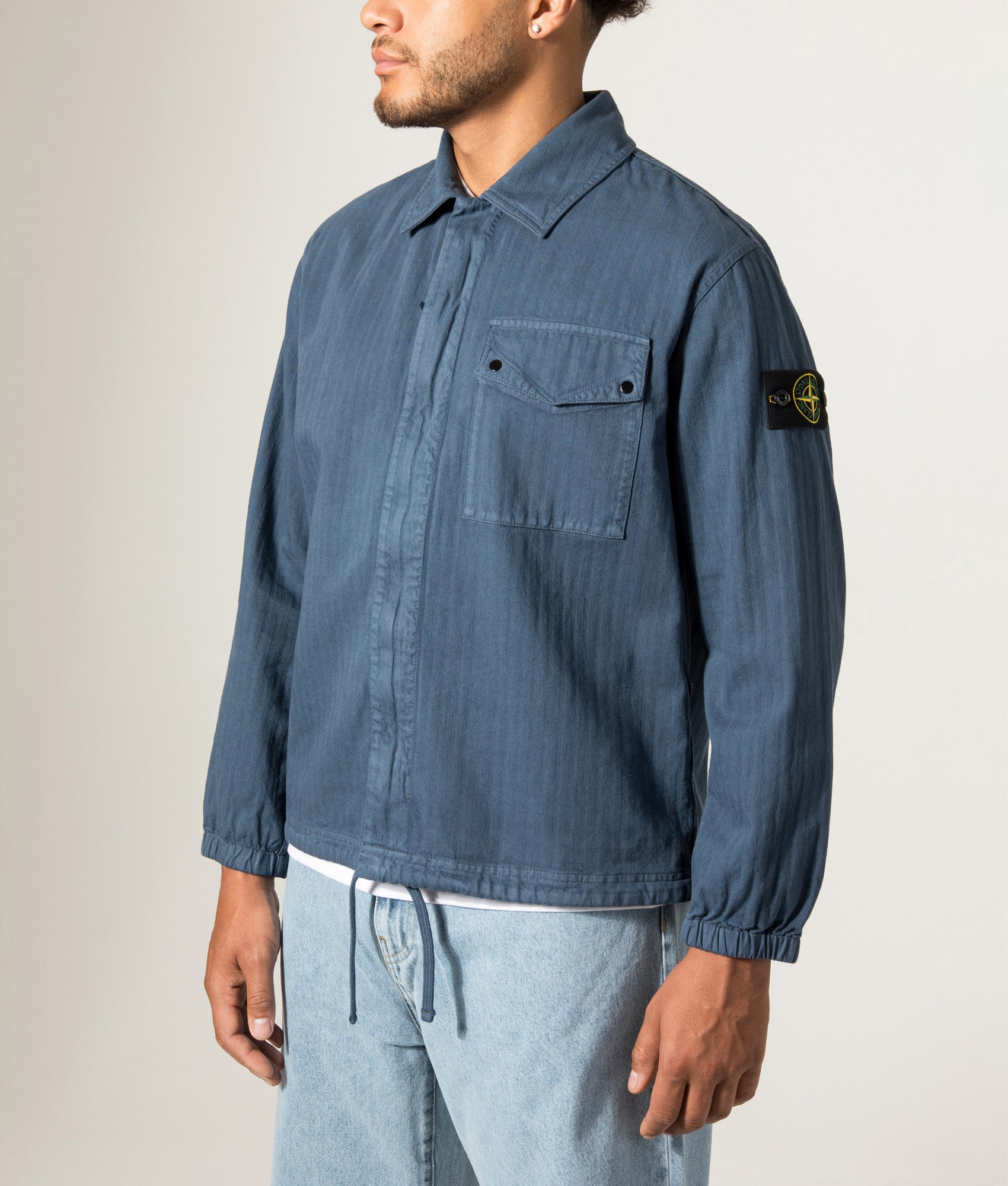 Stone Island Organic Cotton Twill Overshirt in Slate Blue at EQVVS Menswear.  Angled model front shot.