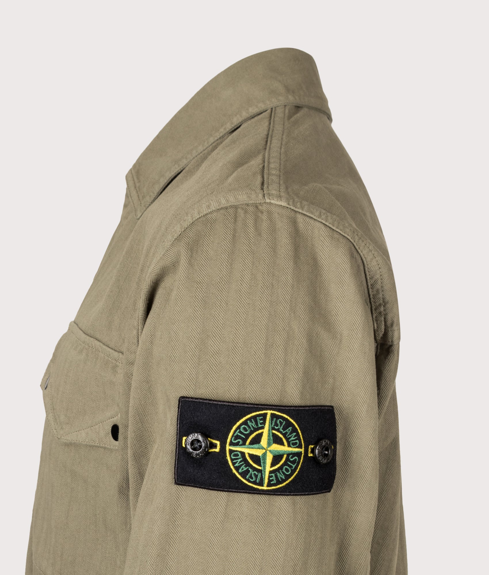 Stone Island Cotton Herringbone Overshirt in Military Green at EQVVS Menswear. Detail shot.