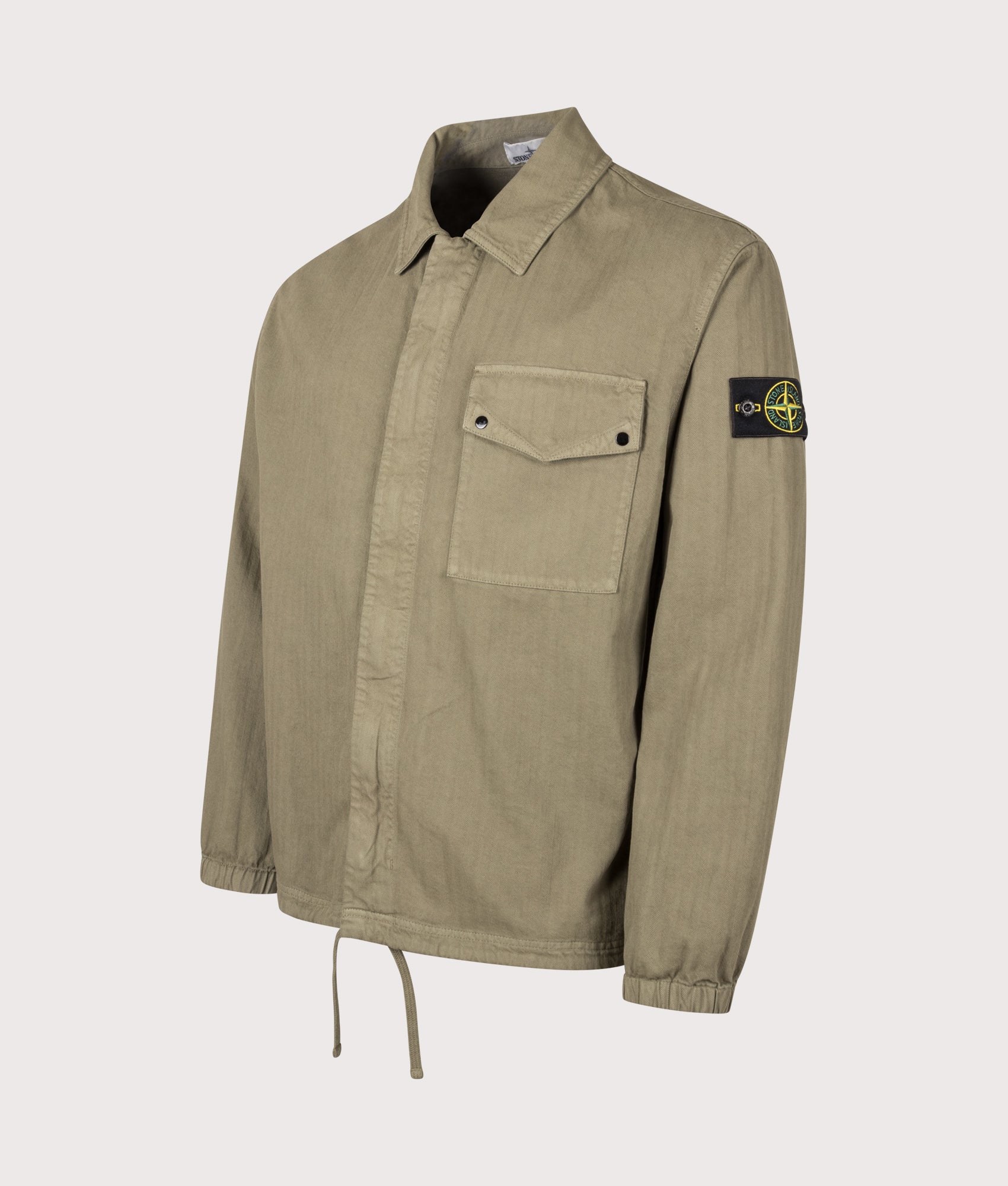 Stone Island Cotton Herringbone Overshirt in Military Green at EQVVS Menswear. Angled front shot.