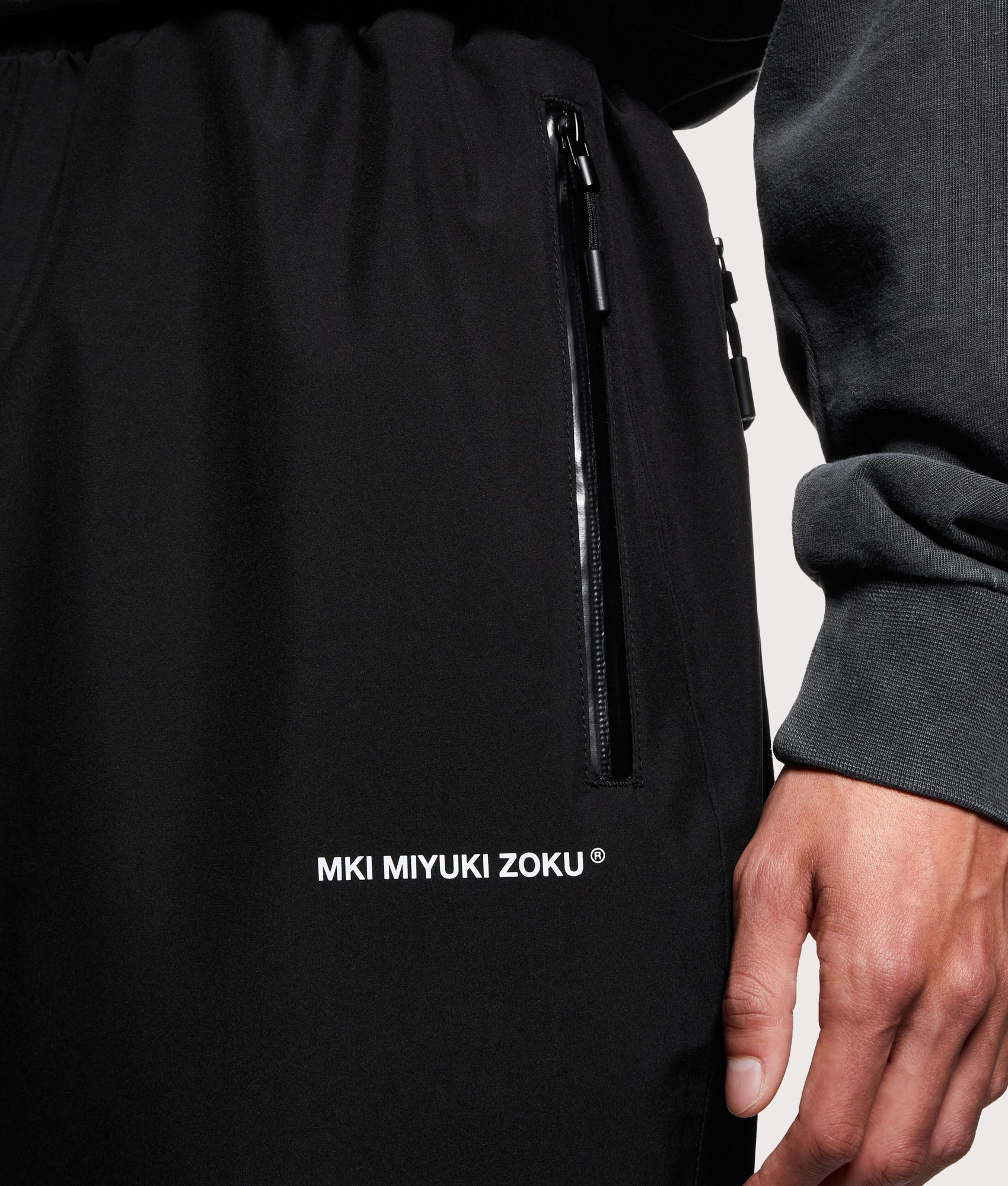 MKI MIYUKI ZOKU V3 Shell Track Pants  in Black at EQVVS Menswear. Detail shot.