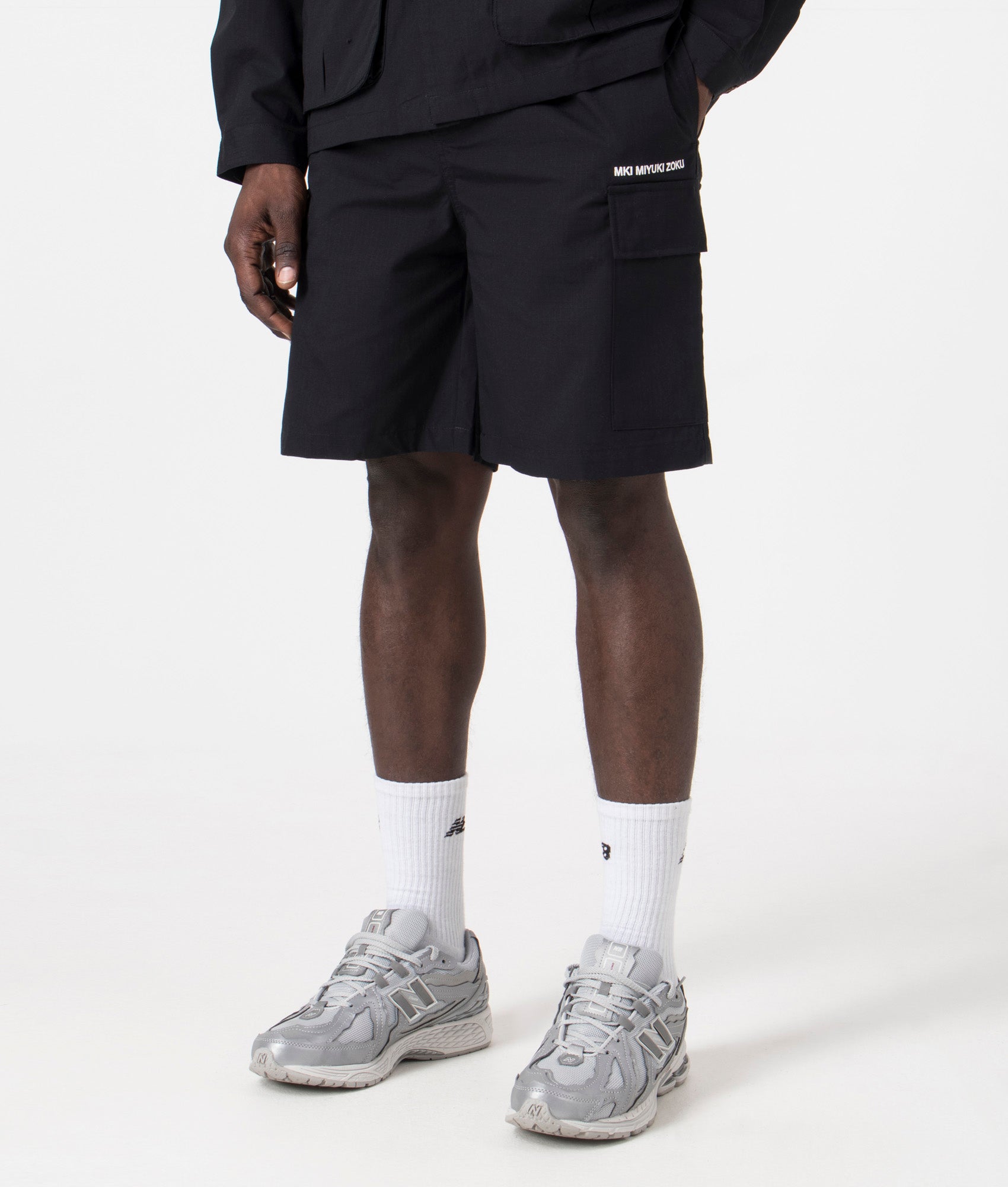 MKI Relaxed Fit Ripstop Cargo Shorts. Side angle model shot at EQVVS.