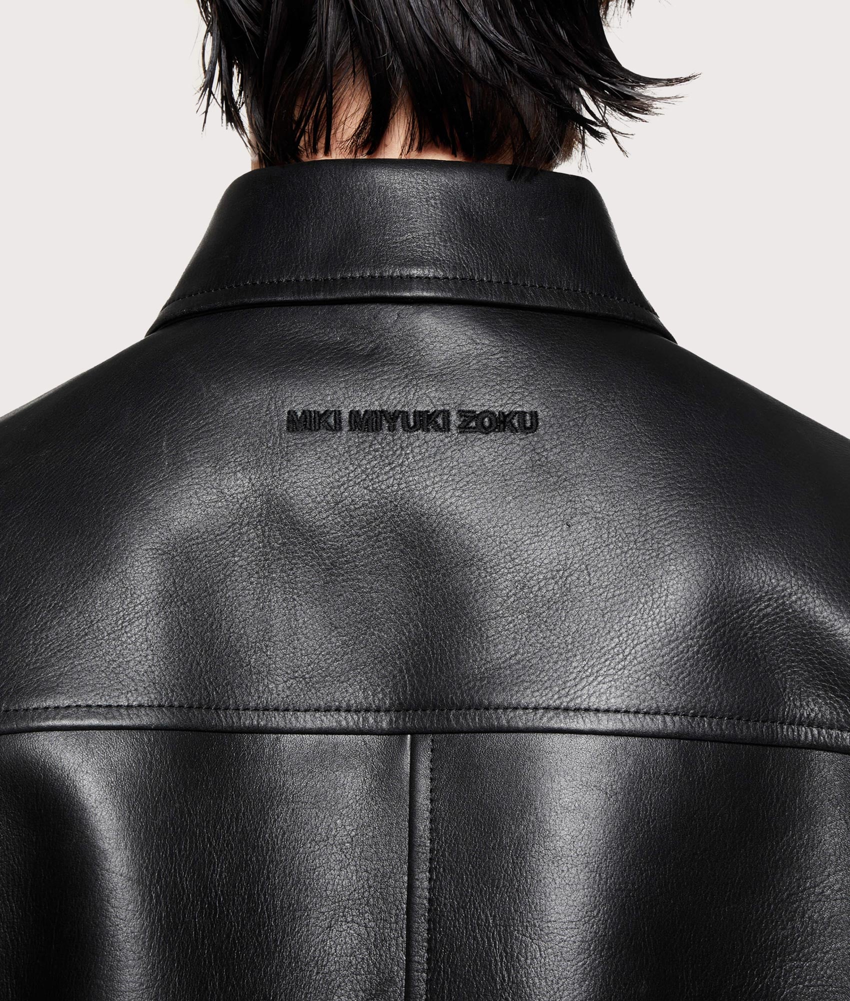 MKI MIYUKI ZOKU Cropped Leather Rider Jacket drops in Black at EQVVS Menswear. Back detail shot.