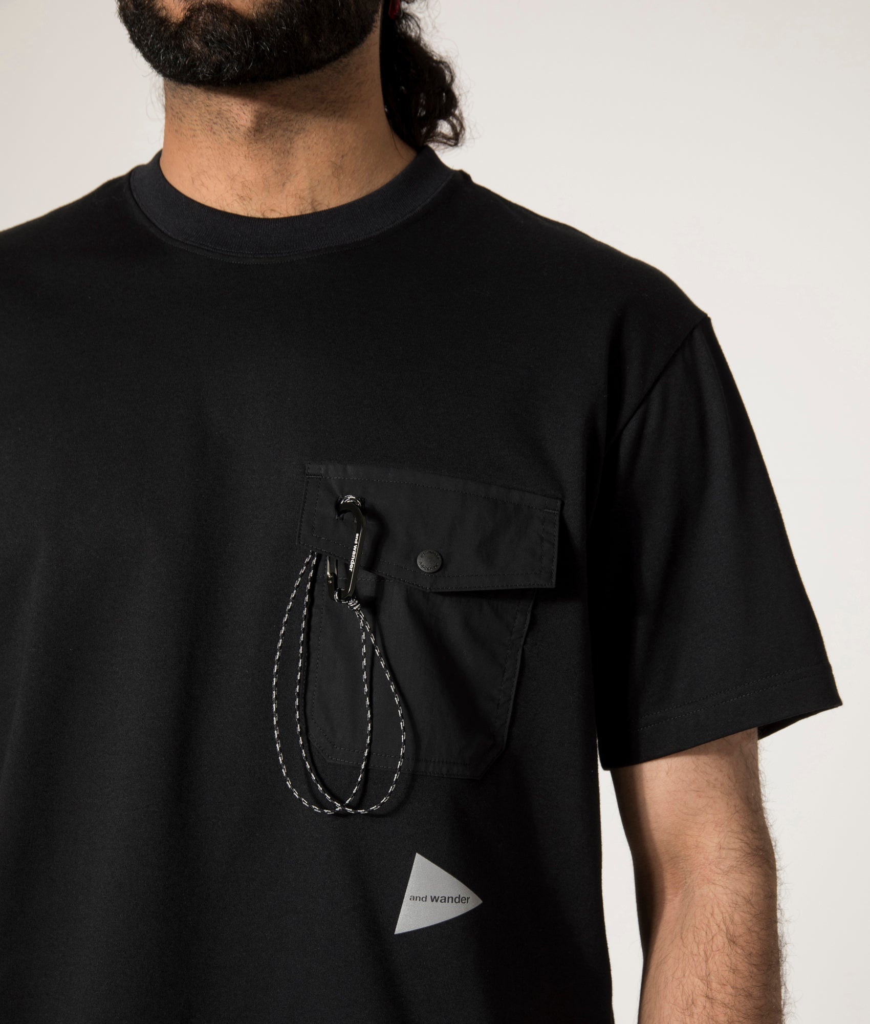 and wander Pocket T-Shirt in Black. Shot at EQVVS. Front Detail Model Shot.