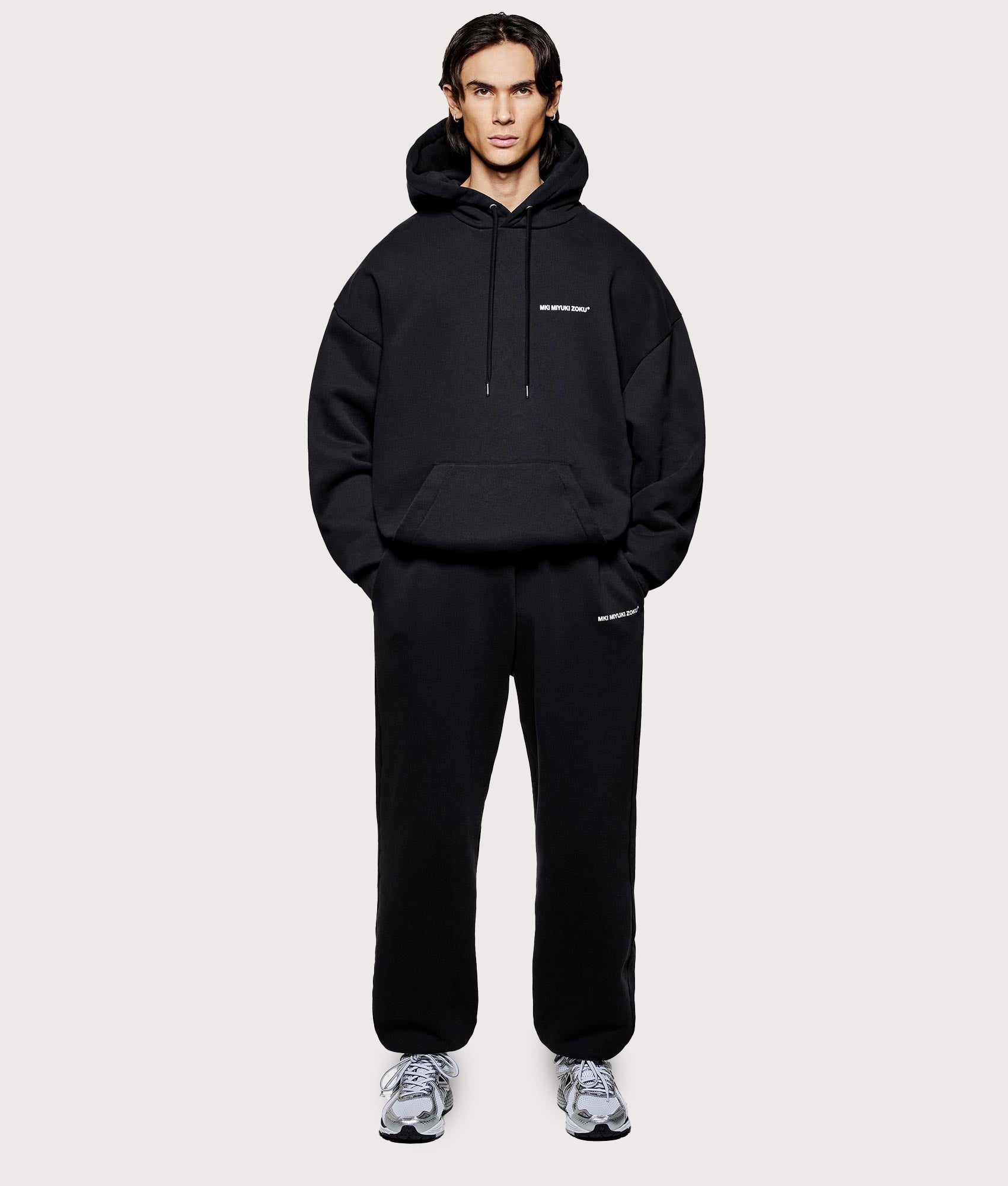 MKI MIYUKI ZOKU Oversized Uniform Hoodie in black at EQVVS Menswear. Model front shot.