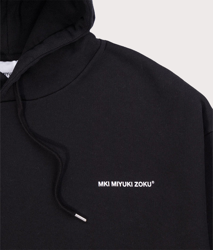 MKI MIYUKI ZOKU Oversized Uniform Hoodie in black at EQVVS Menswear. Detail shot. 