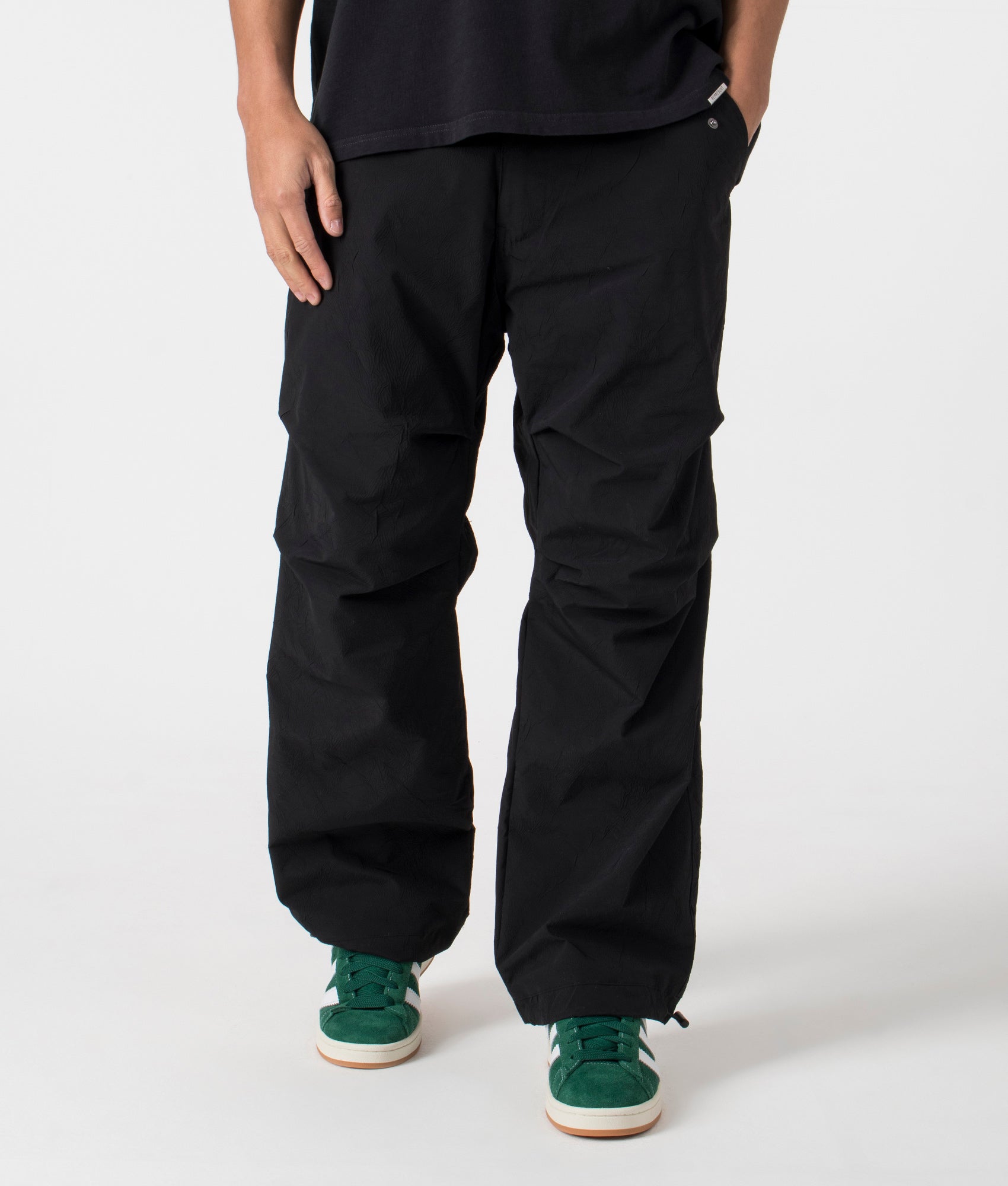 Root Flight Pants in Black by Pleasures. EQVVS Menswear Front Angle Model Shot. 