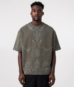 Daily Paper Oversized Secret Rhythm T-Shirt in Chimera Green with Graphic Print, 100% Cotton Front model shot at EQVVS