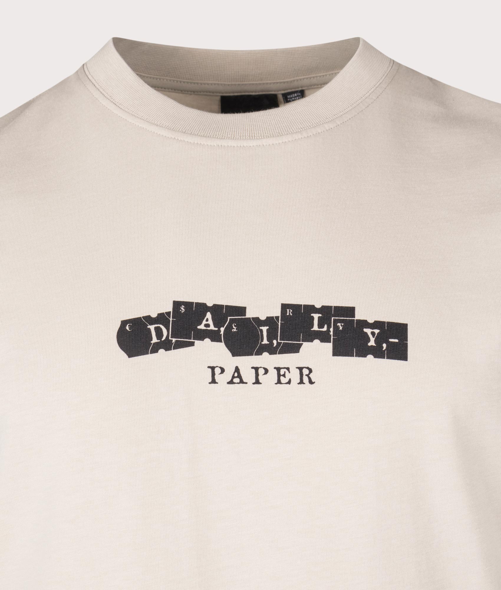 Daily Paper Tag T-Shirt in Nacreous Cloud Beige at EQVVS. Detail Shot.